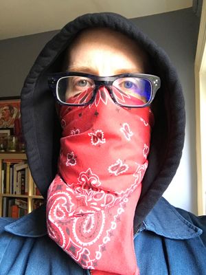 The author covering his face with a red bandana