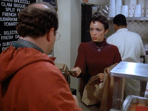 A still from Seinfeld, with the Soup Nazi’s cashier facing George Costanza